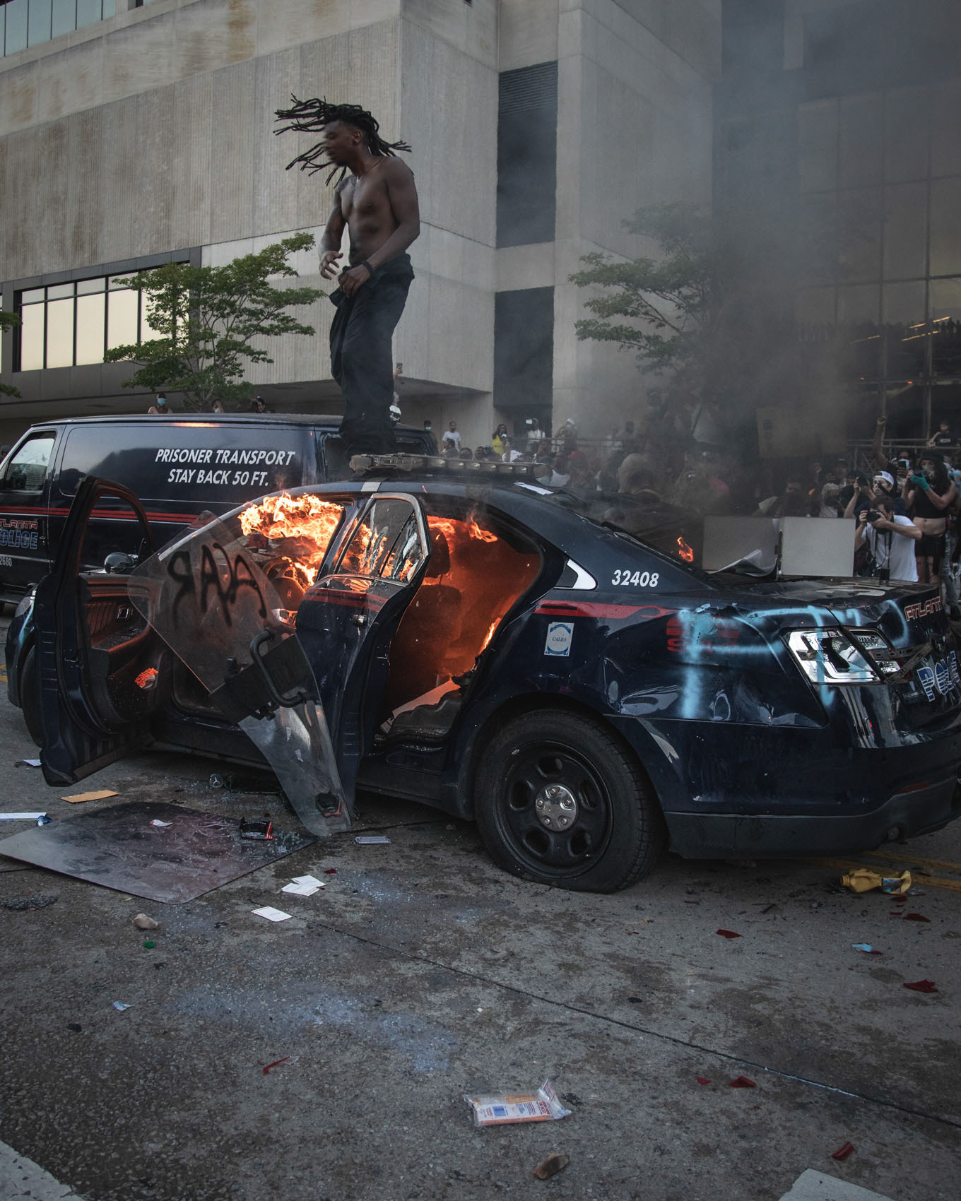 protestor on police car