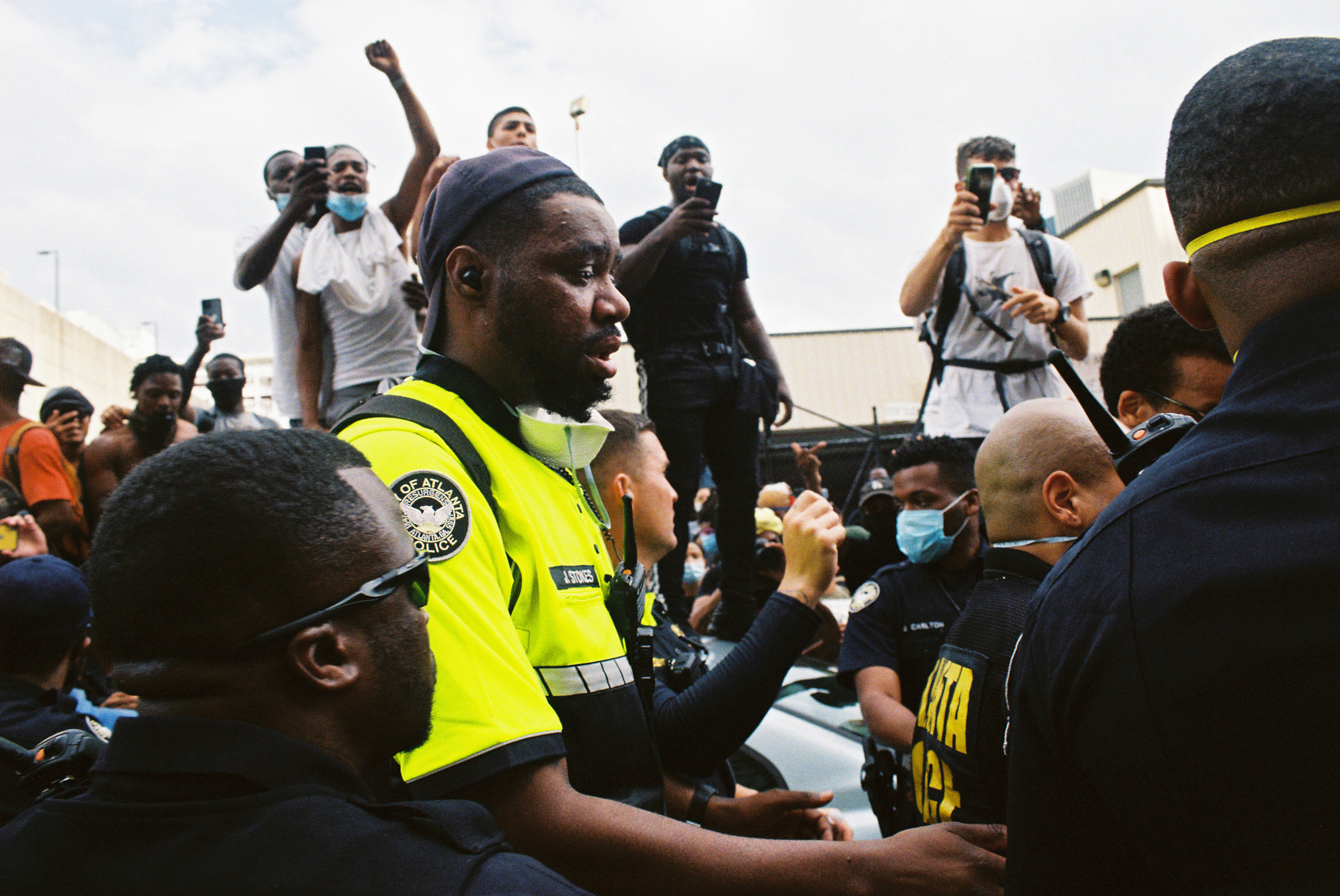APD officer and protestors