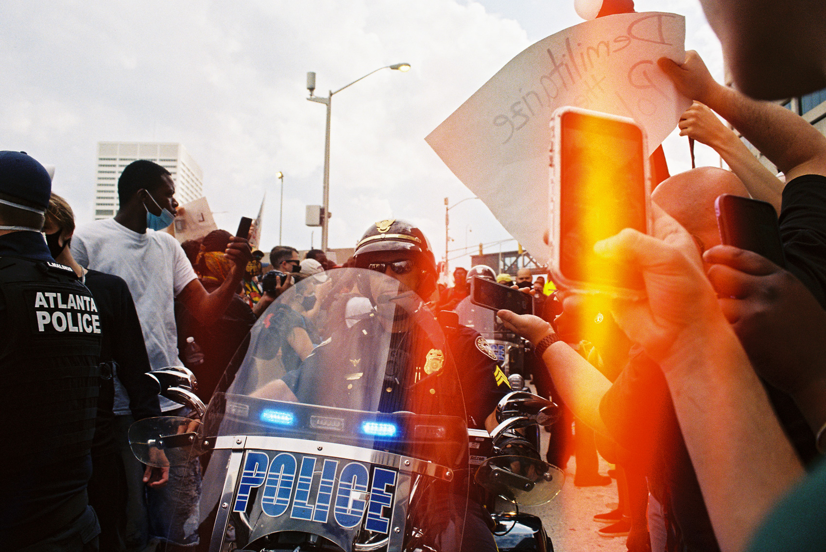 protestors photographing APD officers on cell phones