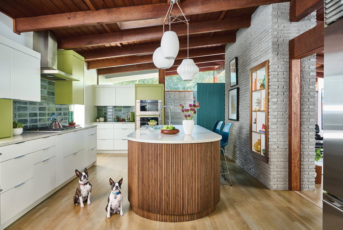 A wood island and ceiling beams bring in the warmth associated with houses of this era. Dogs Fenway (left) and Logan add Boston flair.