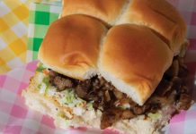Hot Piggy sandwich with slaw, mustard, and hot sauce