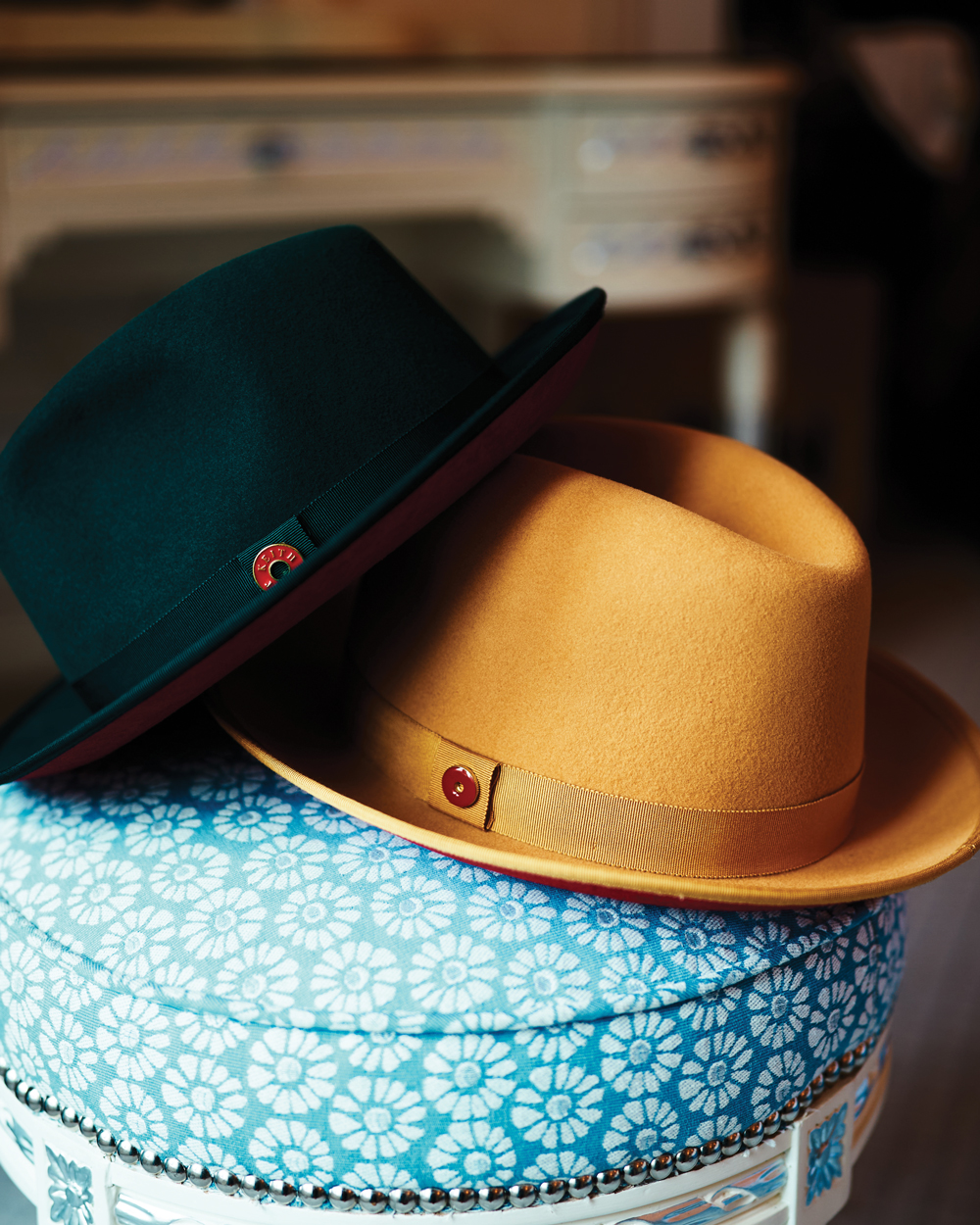 The King, a center-pleated fedora, shown in canary yellow and mean green