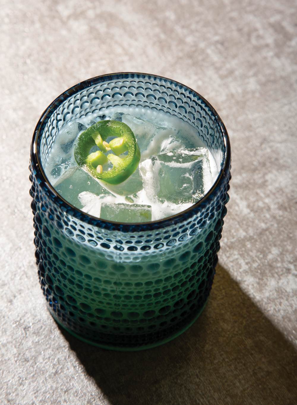 A spicy margarita cocktail with a jalapeno slice at Natalie Bianca