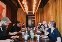 Restaurant workers eating in the dining room at Iberian Pig
