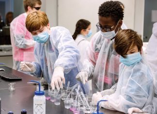 Kids in lab coats identifying the pathogen behind a mock zombie outbreak