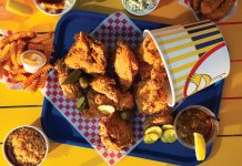 Mothers Best Fried Chicken rules the roost in Decatur Fried chicken spilling out of a bucket, surrounded by iced team, pickles, crinkle fries, and more