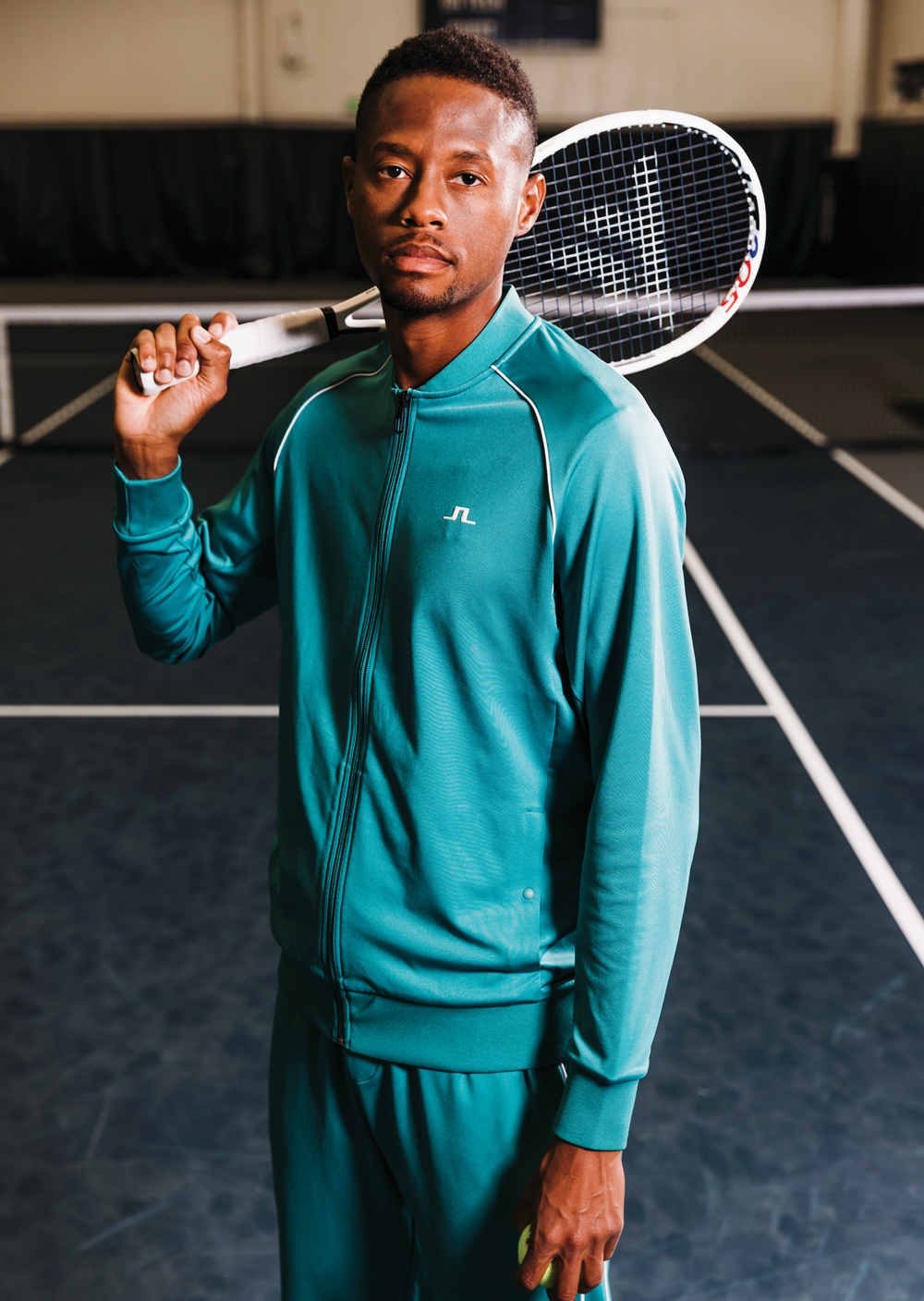 Christopher Eubanks stands with his tennis racket on his shoulder