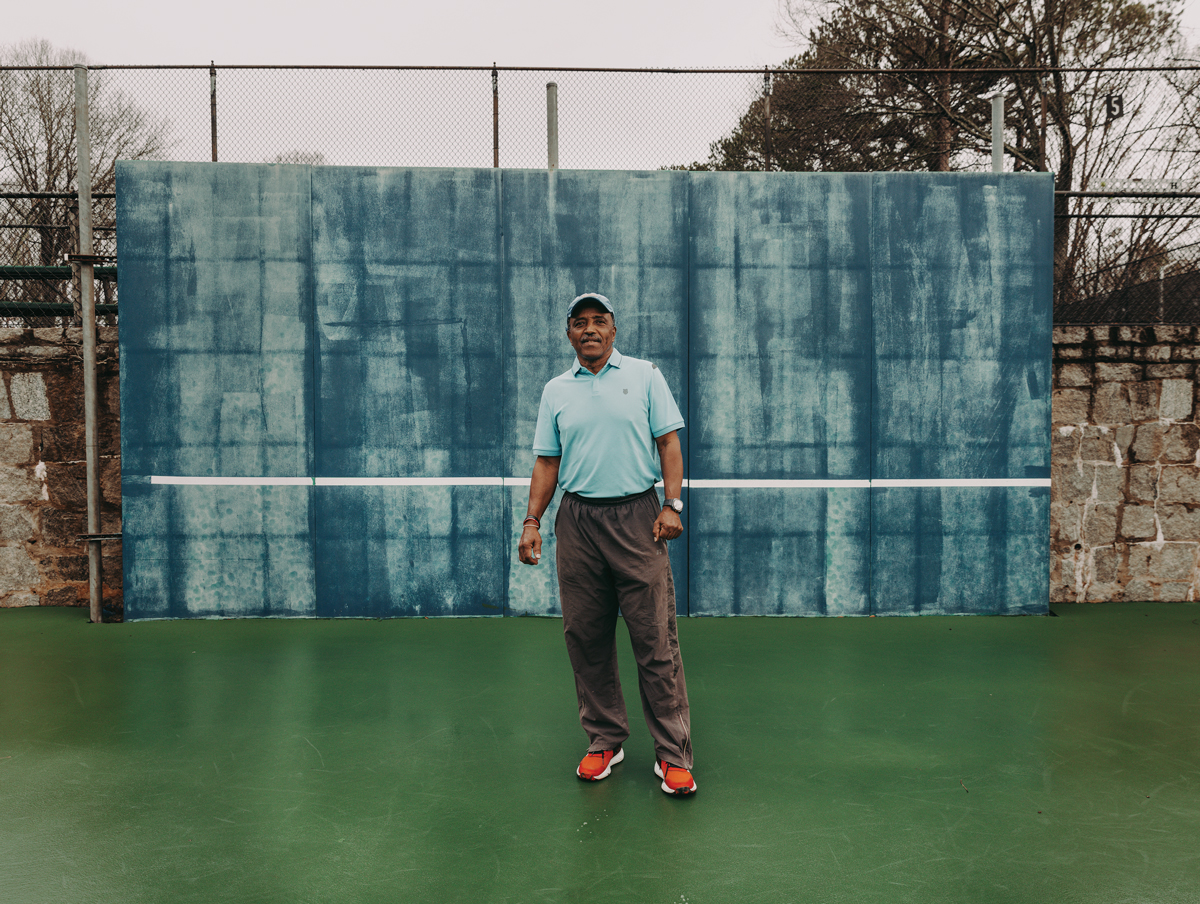 Horace Reid stands on a tennis court