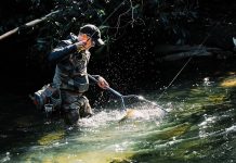 3 outdoor wonderlands for Georgia adventure-seekers a man catches a trout in North Georgia's stream