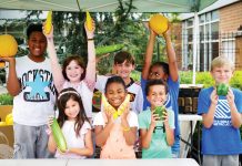Concrete Jungle celebrates 16 years of distributing salvaged fruits and vegetables 8 kids smile and pose while holding vegetables and helping their community