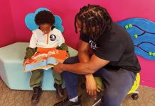 The Library Dads are bonding through books Michael Worthen, a member of The Library Dads, reads with his son.
