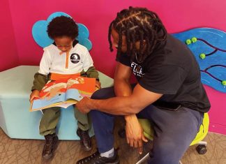 Michael Worthen, a member of The Library Dads, reads with his son.