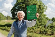 Steve Nygren proudly holds up his book about making change at a local level