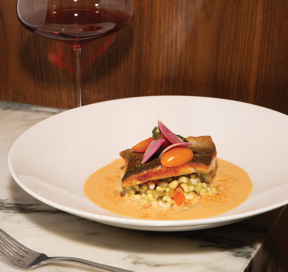trout atop a seasonal vegetable mélange