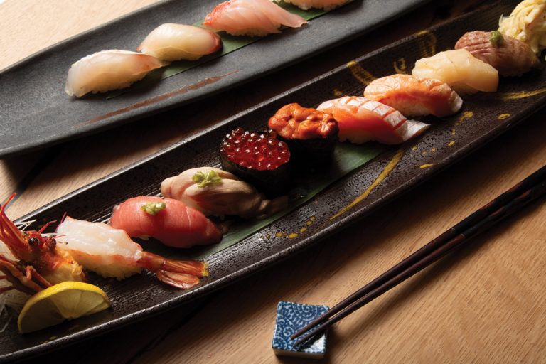 Assorted nigiri on the salvaged wood bar at Nakato