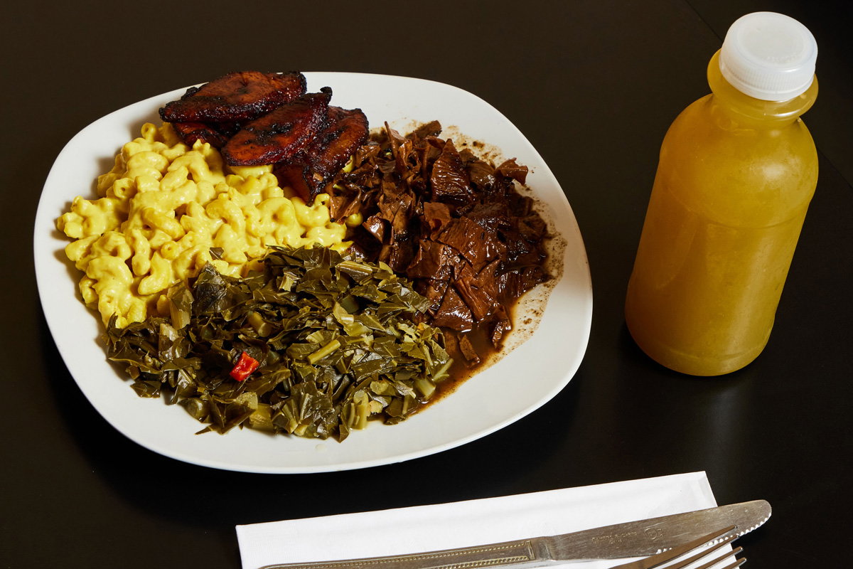 A plate of vegan mac and cheese, sweet plantains, and greens from Healthful Essence in the West End