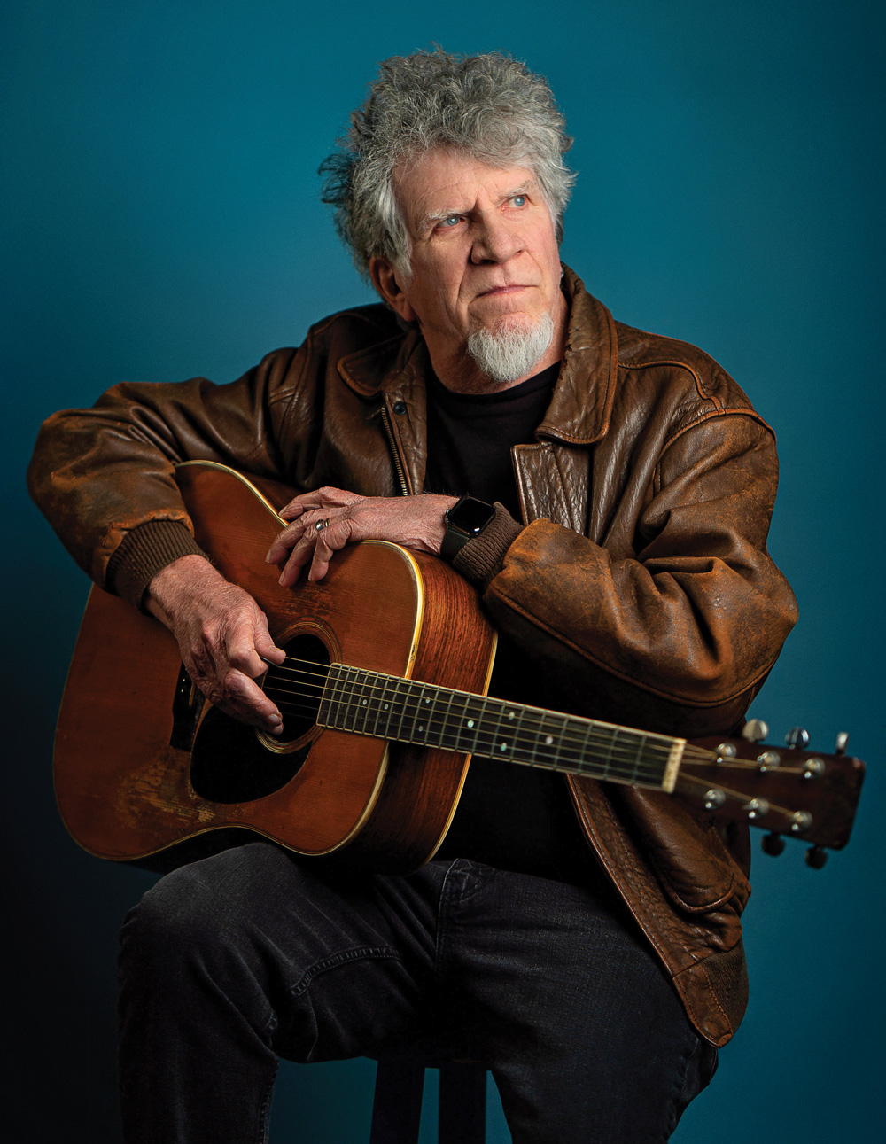 Harrison with his battle-worn Martin D-35 acoustic guitar