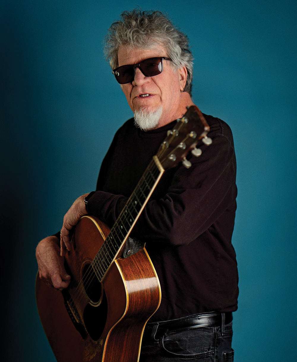 Harrison with his battle-worn Martin D-35 acoustic guitar
