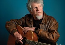 Harrison with his battle-worn Martin D-35 acoustic guitar