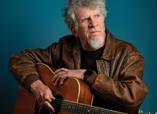 Harrison with his battle-worn Martin D-35 acoustic guitar
