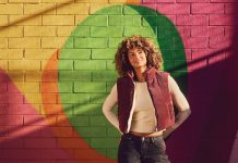 5 solo dates to take in Atlanta this year a model smiles in front of a pink, yellow, orange, and green mural