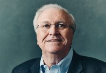 The price of making it: Tom Johnson reflects on power, loss, and what it means to live a meaningful life A portrait photo of Johnson against a blue/grey background