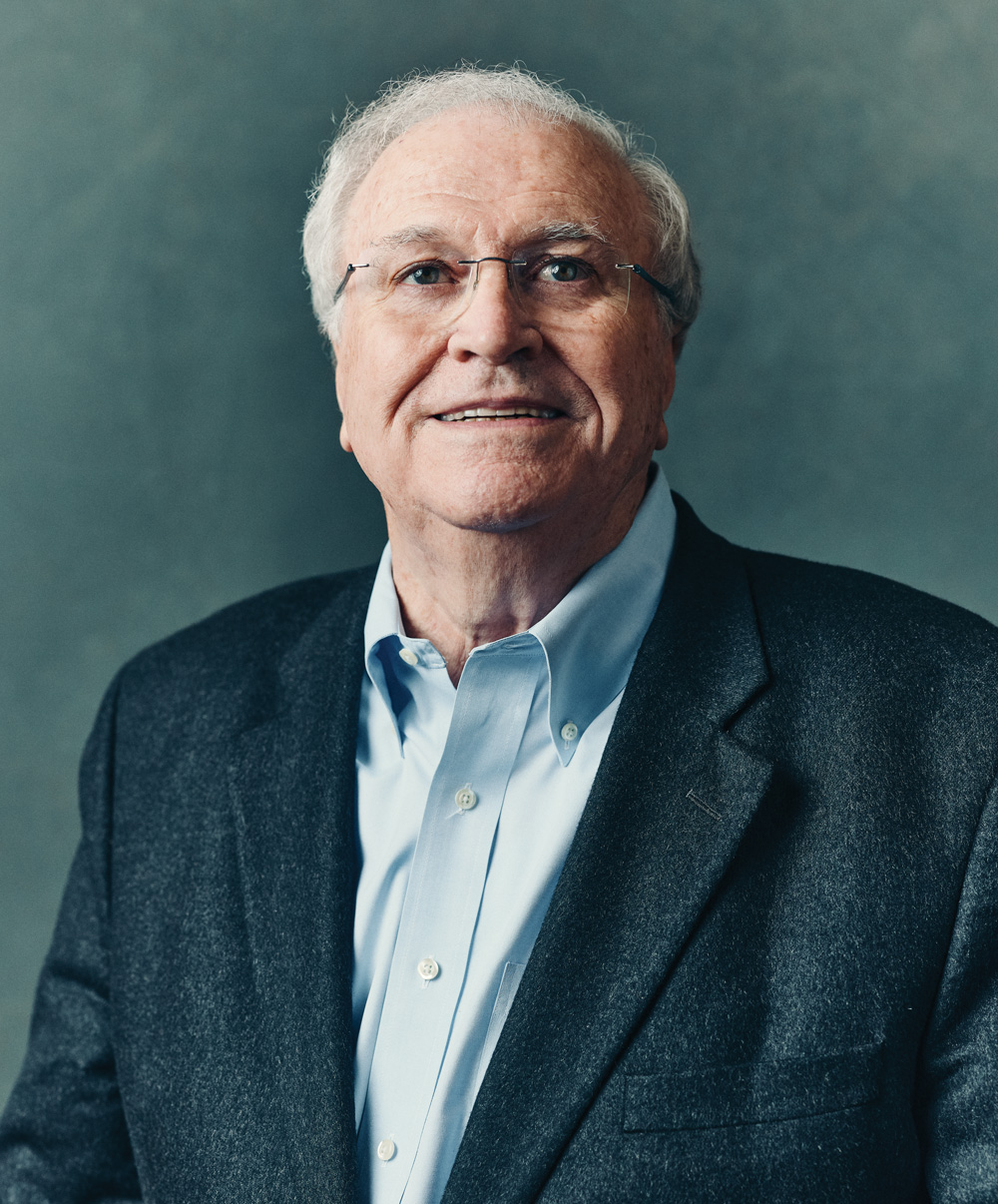 a portrait photo of Johnson against a blue/grey background