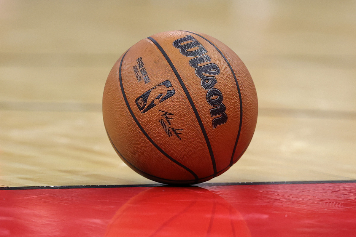 A Wilson basketball sits on an NBA basketball court