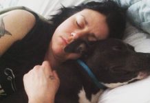 In Plain Sight: Inside the unsolved Piedmont Park murder that shook Atlanta Katie Janness has her eyes closed as she lays in bed, hugging her dog, Bowie