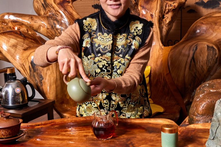 Amy Zhang wears a ceremonial vest for tea service at Wai’s Gong Fu Tea House.