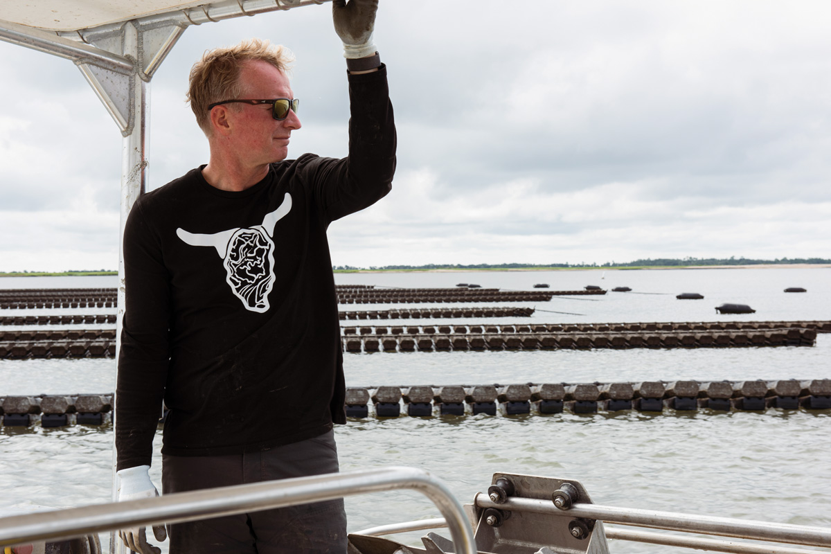 Perry Solomon stands on a boat