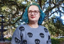 Enocha Edenfield in a grey sweater with black skulls