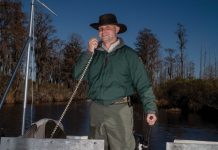 A swamp storyteller shares insider tips for the Okefenokee Richard Rhodes, speaks into a microphone on the boat