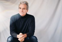 In his memoir, Tom Junod excavates the family secrets that made him who he is today Tom Junod sits in a chair against a white backdrop, wearing a dark turtleneck and jeans
