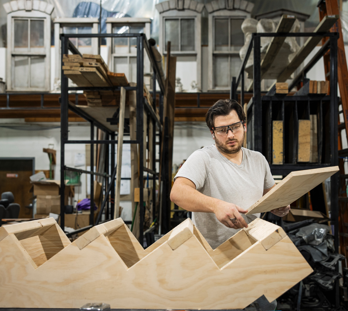 Spencer Antoci puts together the stairs for the two-story house set