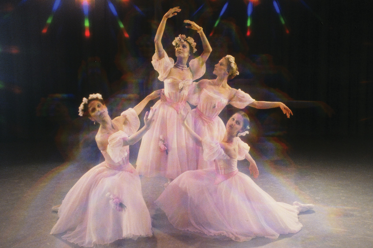 four ballerinas pose together, dresser in pastel pink, tulle dresses and flower crowns