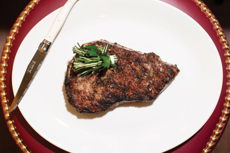 The 12-ounce bone-in dry-aged New York strip steak