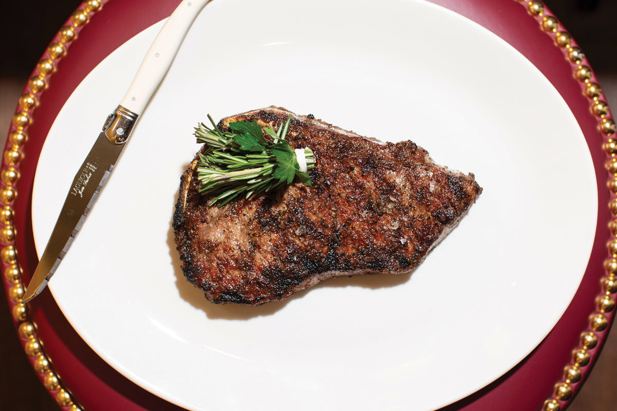 The 12-ounce bone-in dry-aged New York strip steak