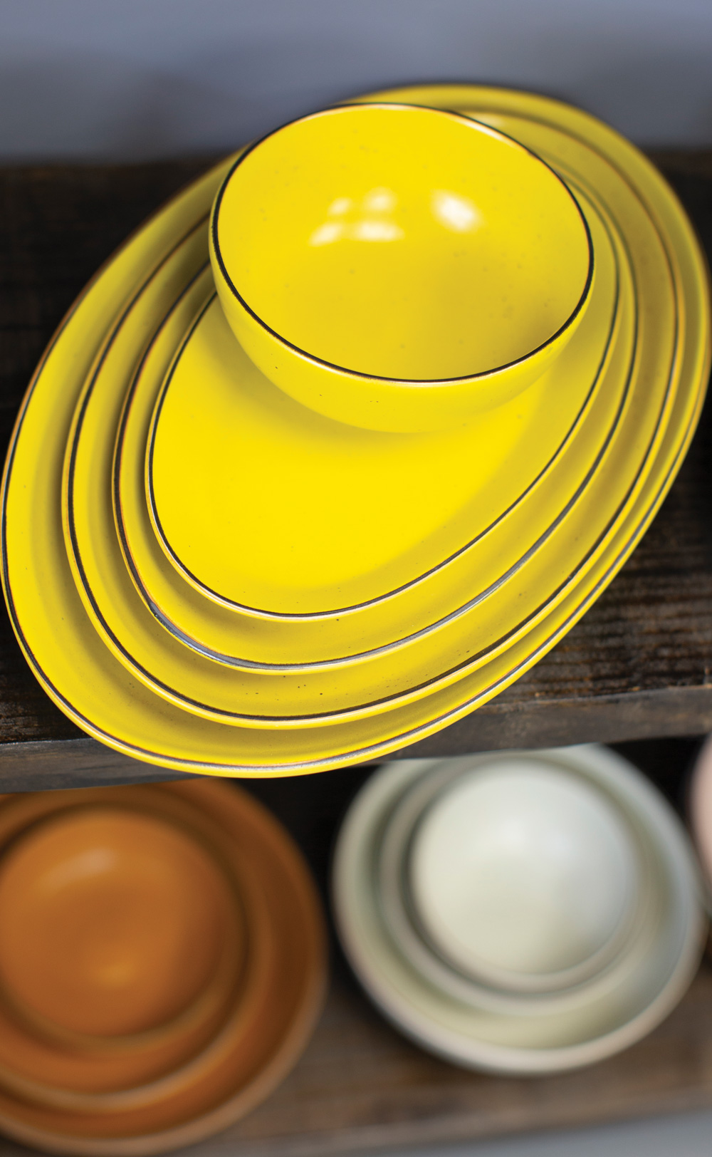 matching bowls and plates in yellow, orange, and white