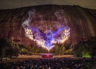 a drone show displays the shape of an eagle in front of a crowd of people at Stone Mountain Park