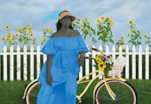 a woman in a blue dress stands by her bike with a white dog in the basket and a white picket fence in the background