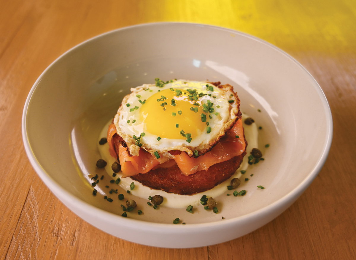 Babygirl offers breakfast items like this hash brown patty with salmon, egg, crema, and capers all day