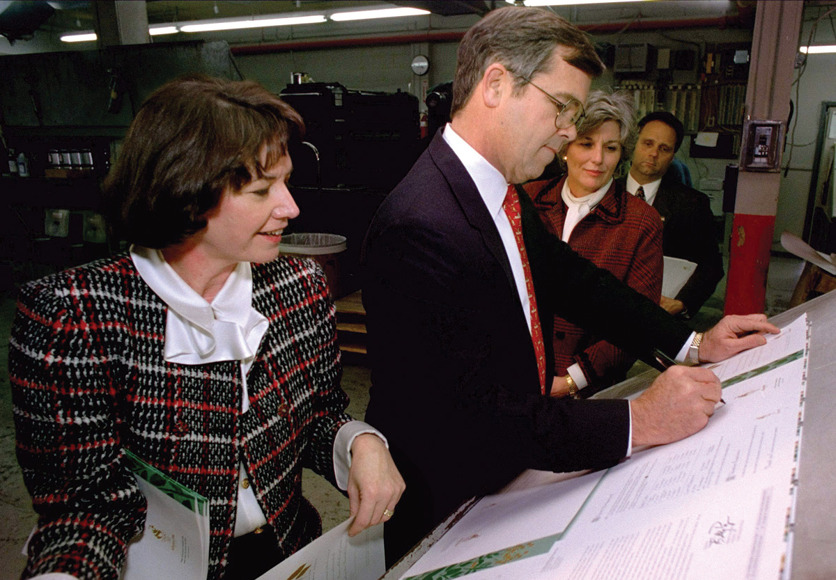 Linda Stephenson, Billy Payne, and Ginger Watkins look at Olympic volunteer applications in 1995