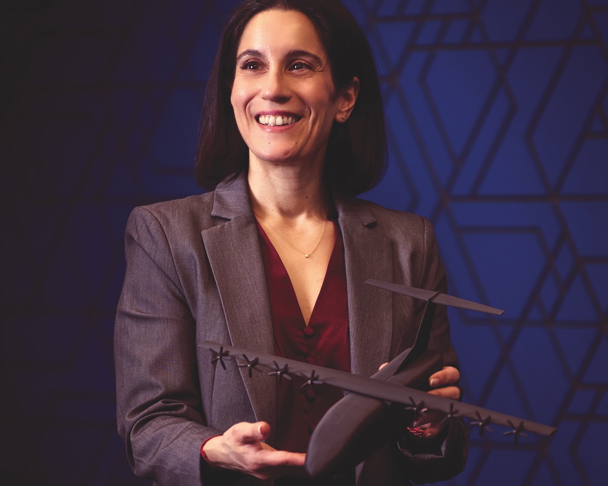 Nadine Auda holds a 3D-printed cargo aircraft model.