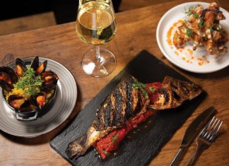 At Que-riosity, Todd Richards gives barbecue a fine dining remix Grilled branzino with stewed tomatoes and mussels next to chicken wings over waffles