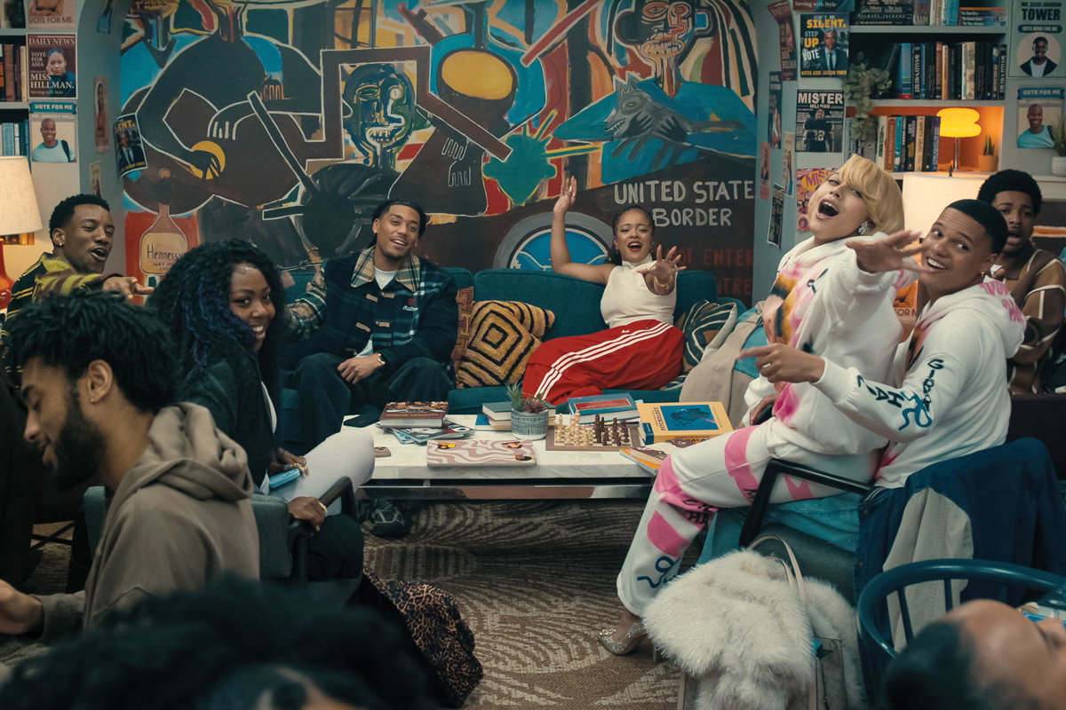 The sequel to A Different World actors at a house party with colorful walls behind them
