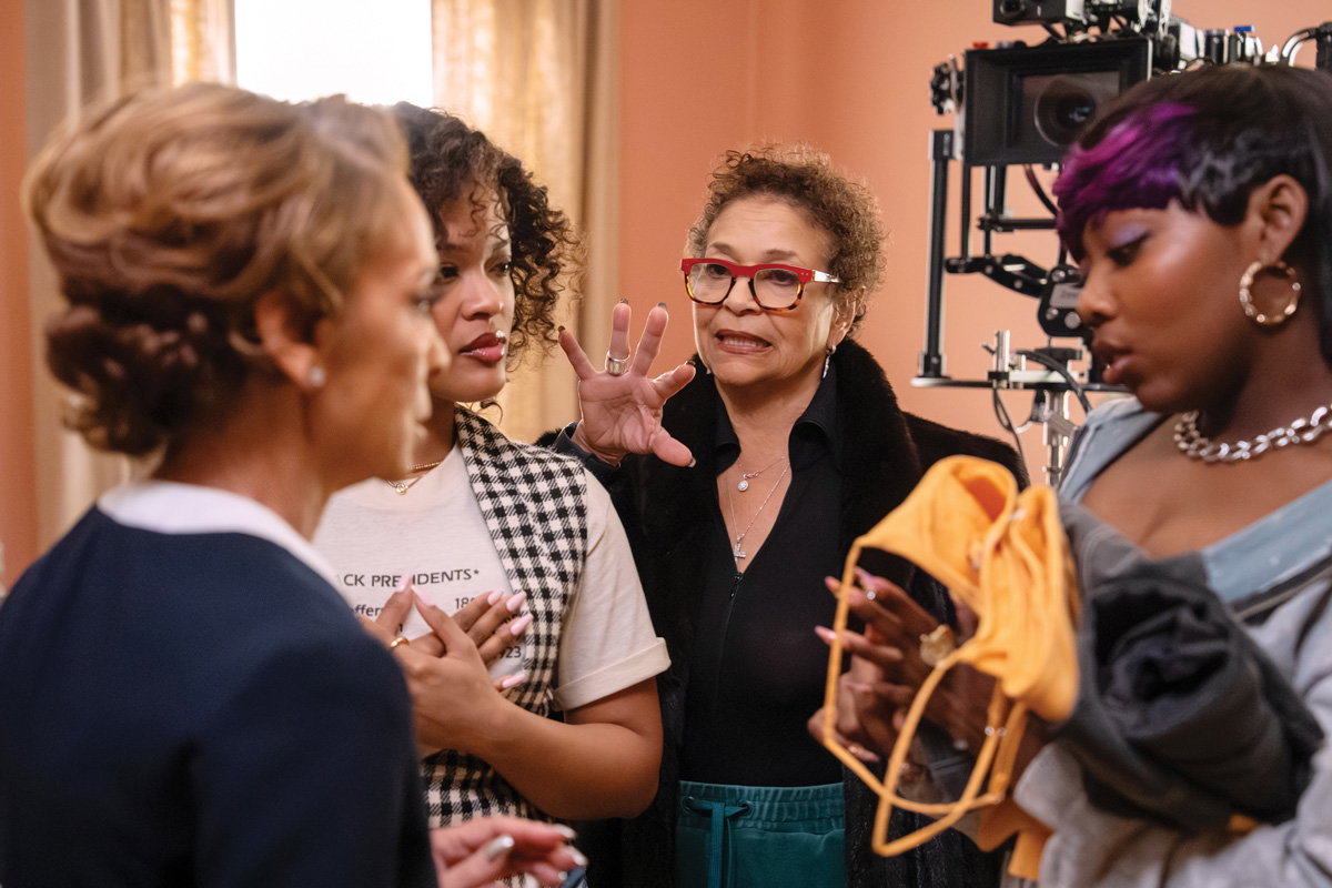 executive producer Debbie Allen (center right) with Jasmine Guy (left) on set