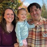Maeve Ross (middle), three years old and thriving, with her parents