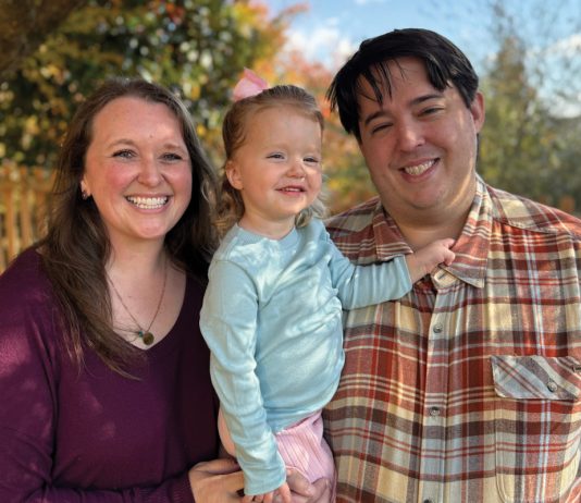 Maeve Ross (middle), three years old and thriving, with her parents