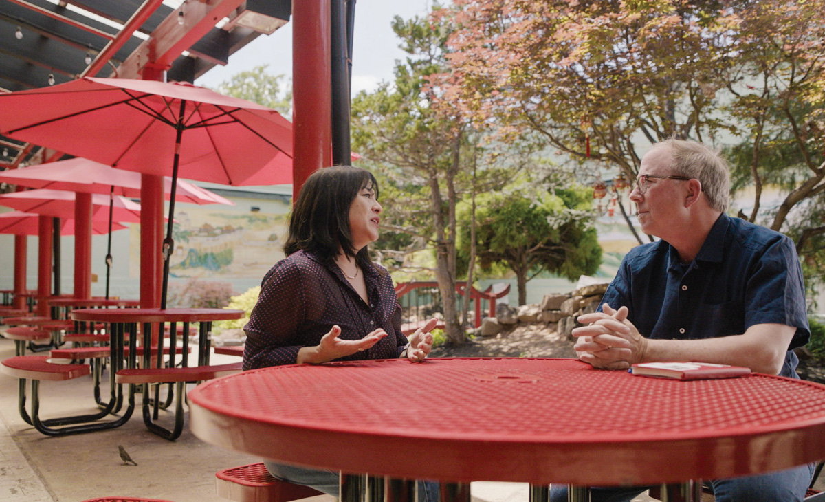 Lily Pabian (left) of We Love Buford Highway with John T. Edge at Atlanta Chinatown courtyard